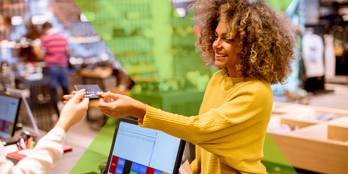 An employee using a cashback card in a retail setting to save money, which is one of many answers to the question "what are fringe benefits?"