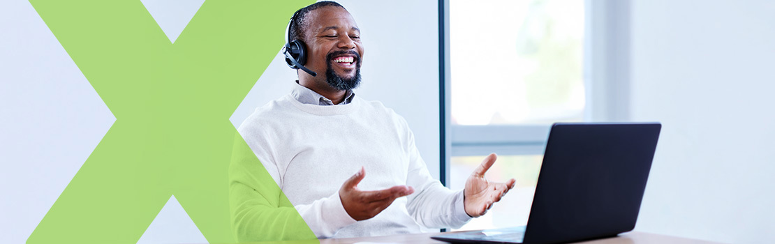 A middle-aged employee smiling and speaking through a headset, showing how retention is the fifth stage of the employee lifecycle