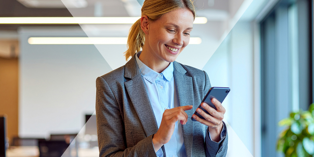 A close up of someone admiring their new phone in the office, showing how employees can save on new technology through a tech scheme