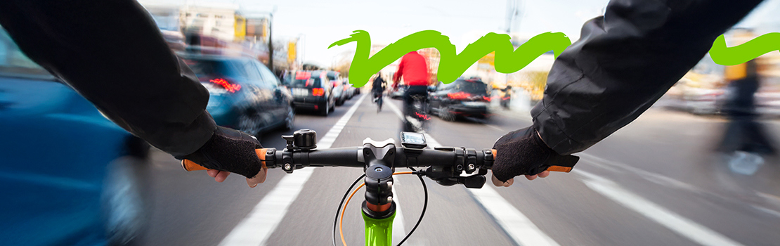 Commuter riding a bike to work through city traffic using a bike to work scheme