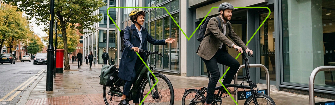 Two employees arriving at their city office on new bikes they bought through Cyclescheme, showing a shared culture of fringe benefits useage