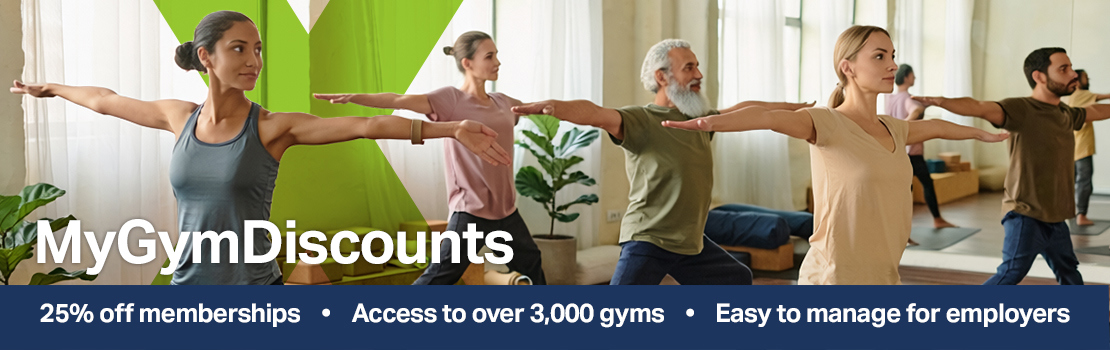 A yoga class taking place in a fitness centre, showing how healthy employees is one of the benefits of offering employee gym memberships