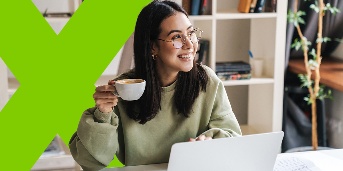 A happy female employee working in a bright home office, showing positive team morale that comes from remote team building